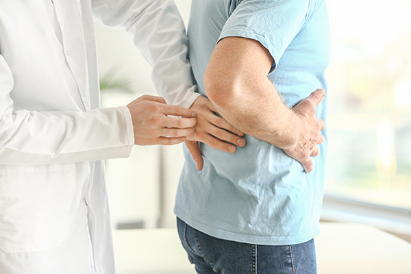 Provider examining patient's back