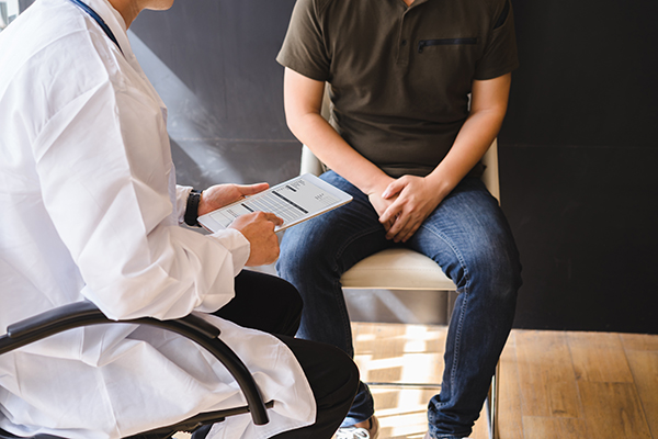 Urology consultation, doctor talking to a male patient